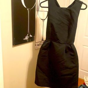 Black high neck above the knee dress with a bow tie back and zipper. New w/ tag